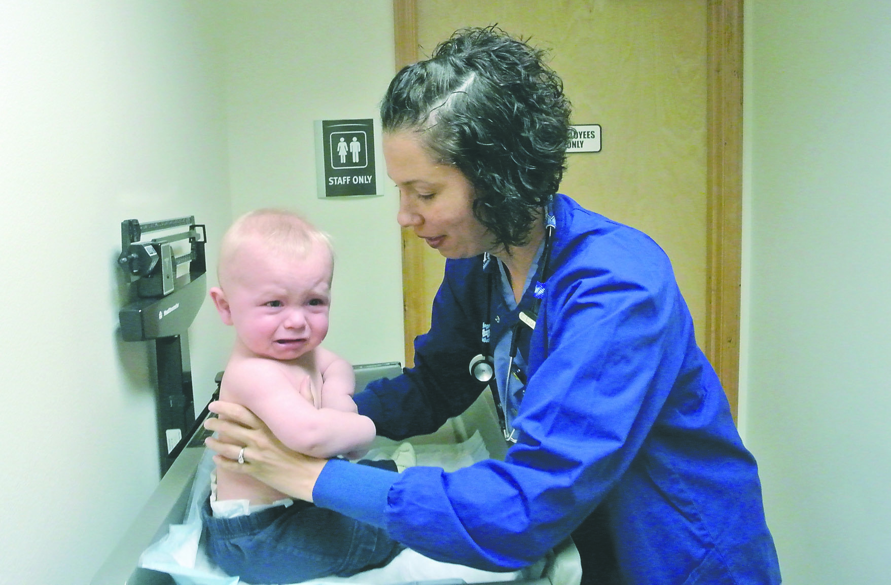 Nine-month-old Jack Ayer of Port Townsend looks none too pleased about getting weighed by Kirsten Pickard