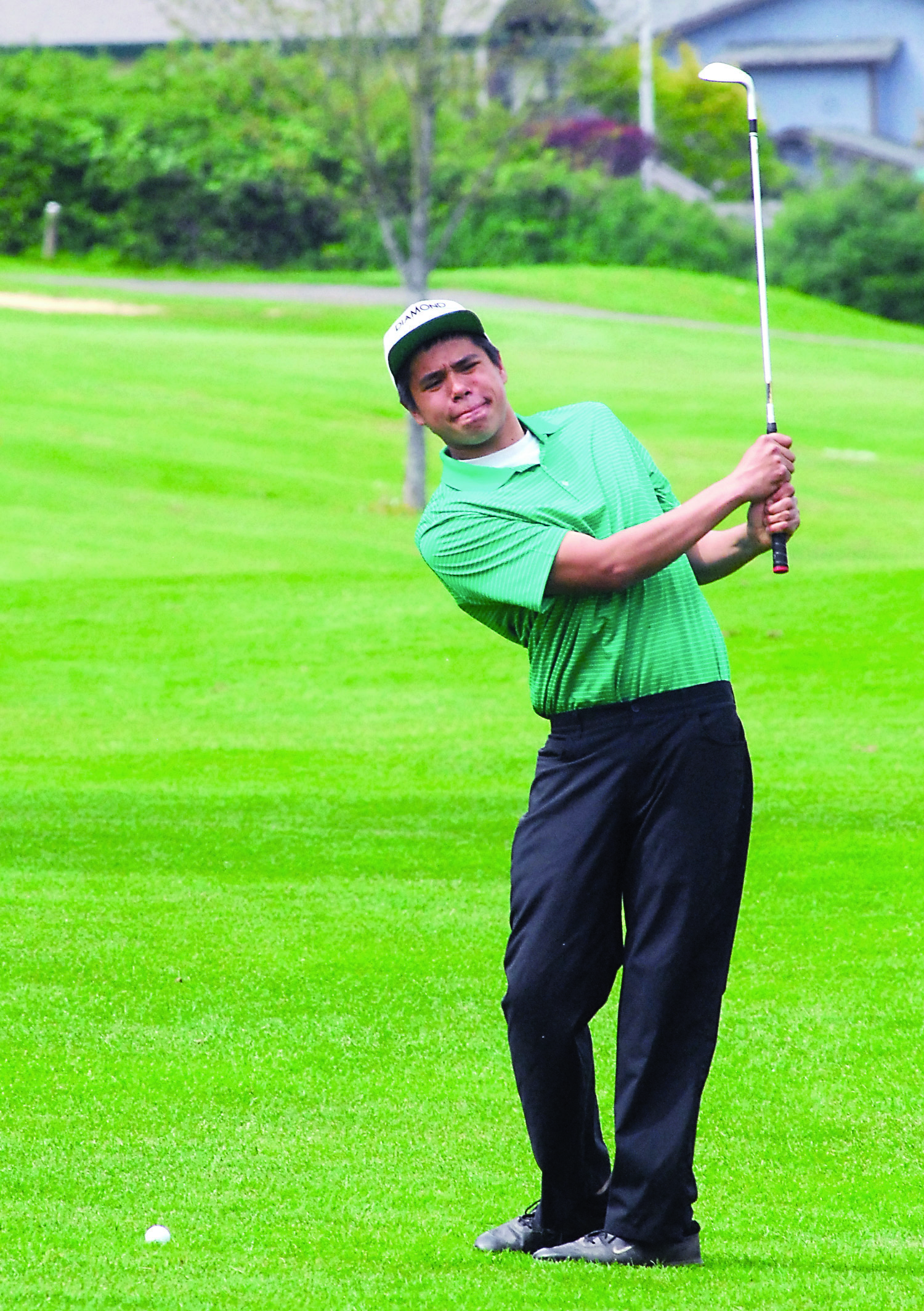 Port Angeles' Micah Needham practices his approach shot on the second hole at Peninsula Golf Club. Keith Thorpe/Peninsula Daily News