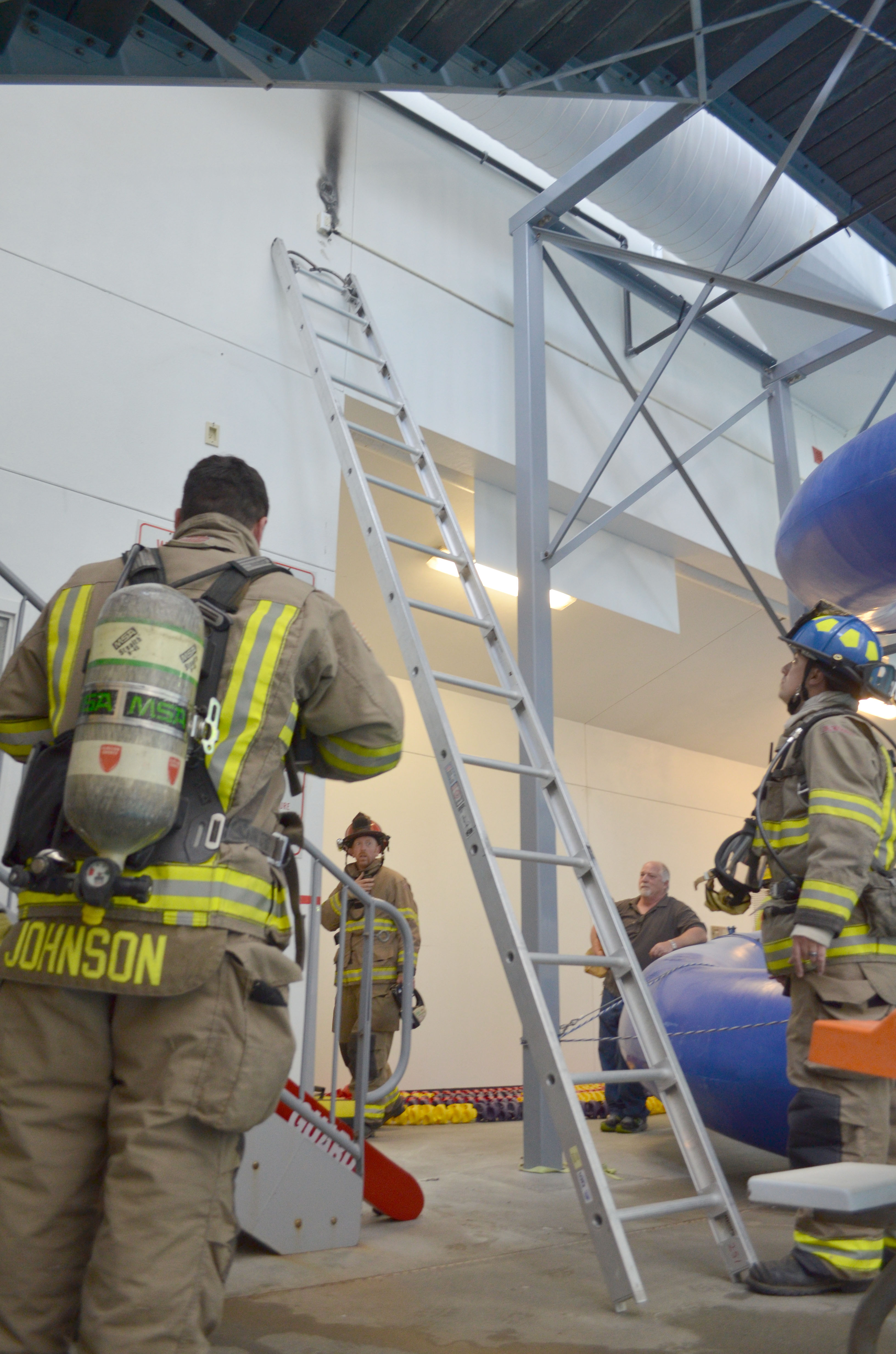 Firefighters with Clallam Fire District No. 3 survey the minor damage caused by a fan fire Monday afternoon at Sequim Aquatic Recreation Center. Patrick Young/Clallam Fire District No. 3
