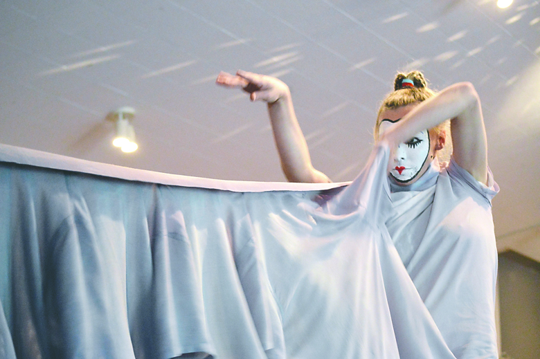 Karyn Temple dances in and out of a 19-sleeve coat made by Paula Lalish in Saturday's Port Townsend Wearable Art Show. The work