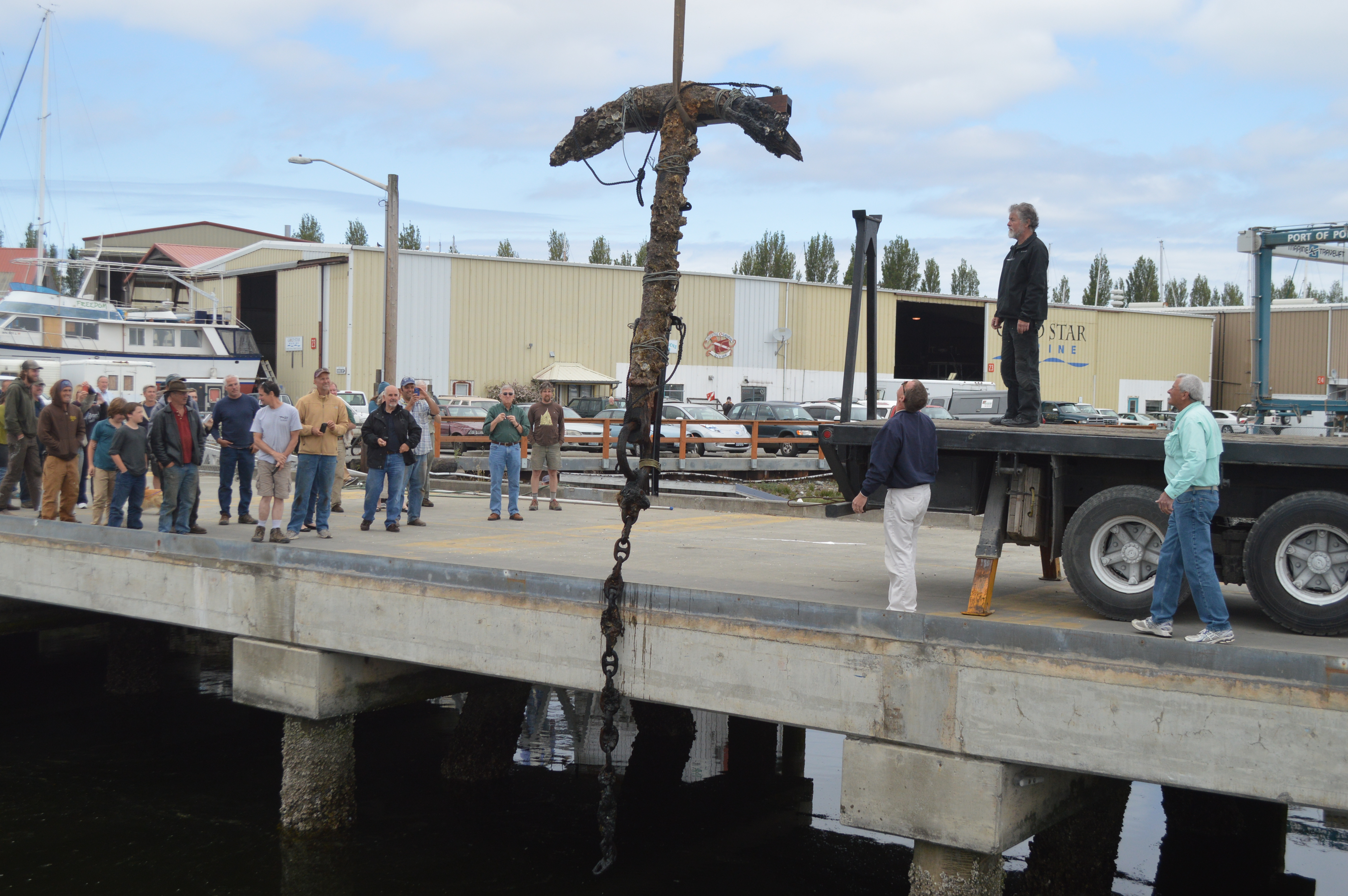 An anchor believed by amateur historians and local divers is pulled from the water at the Port of Port Townsend Boat Haven this afternoon. Joe Smillie/Peninsula Daily News