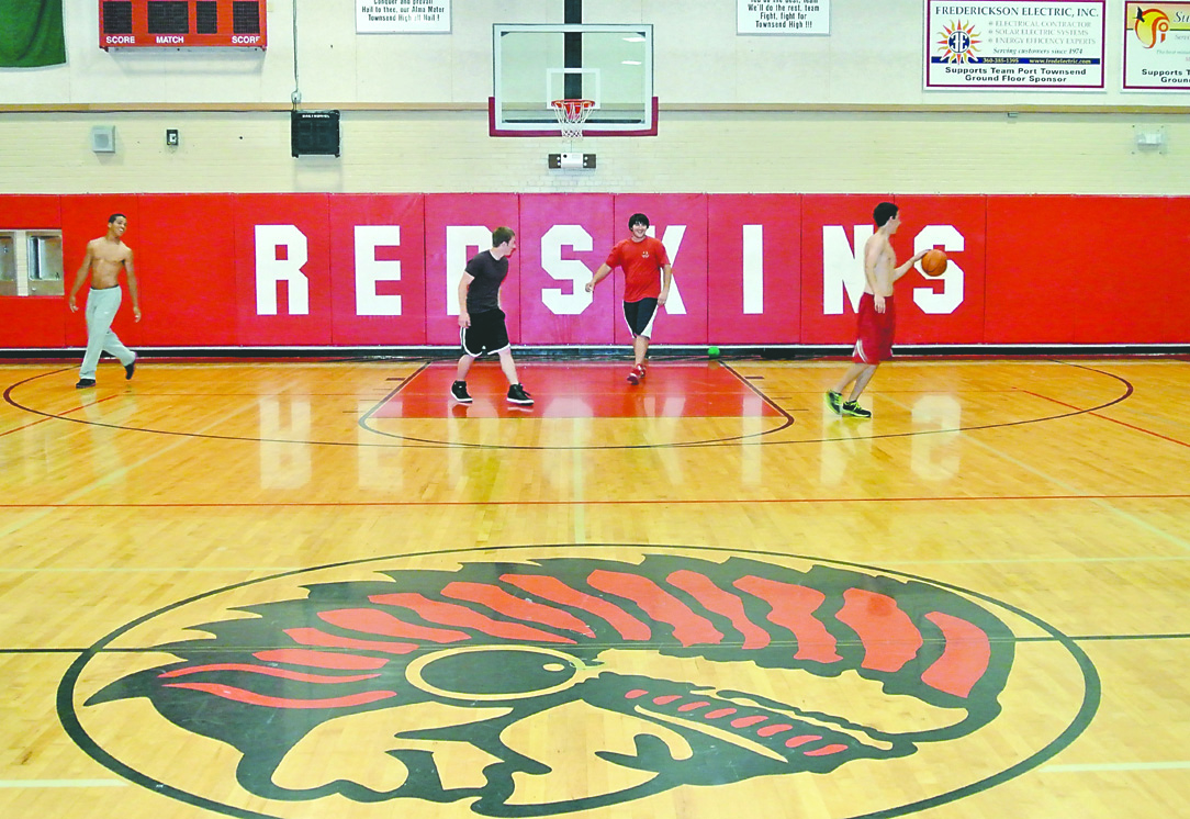Port Townsend High School students play basketball in the gym surrounded by Redskins regalia. Charlie Bermant/Peninsula Daily News