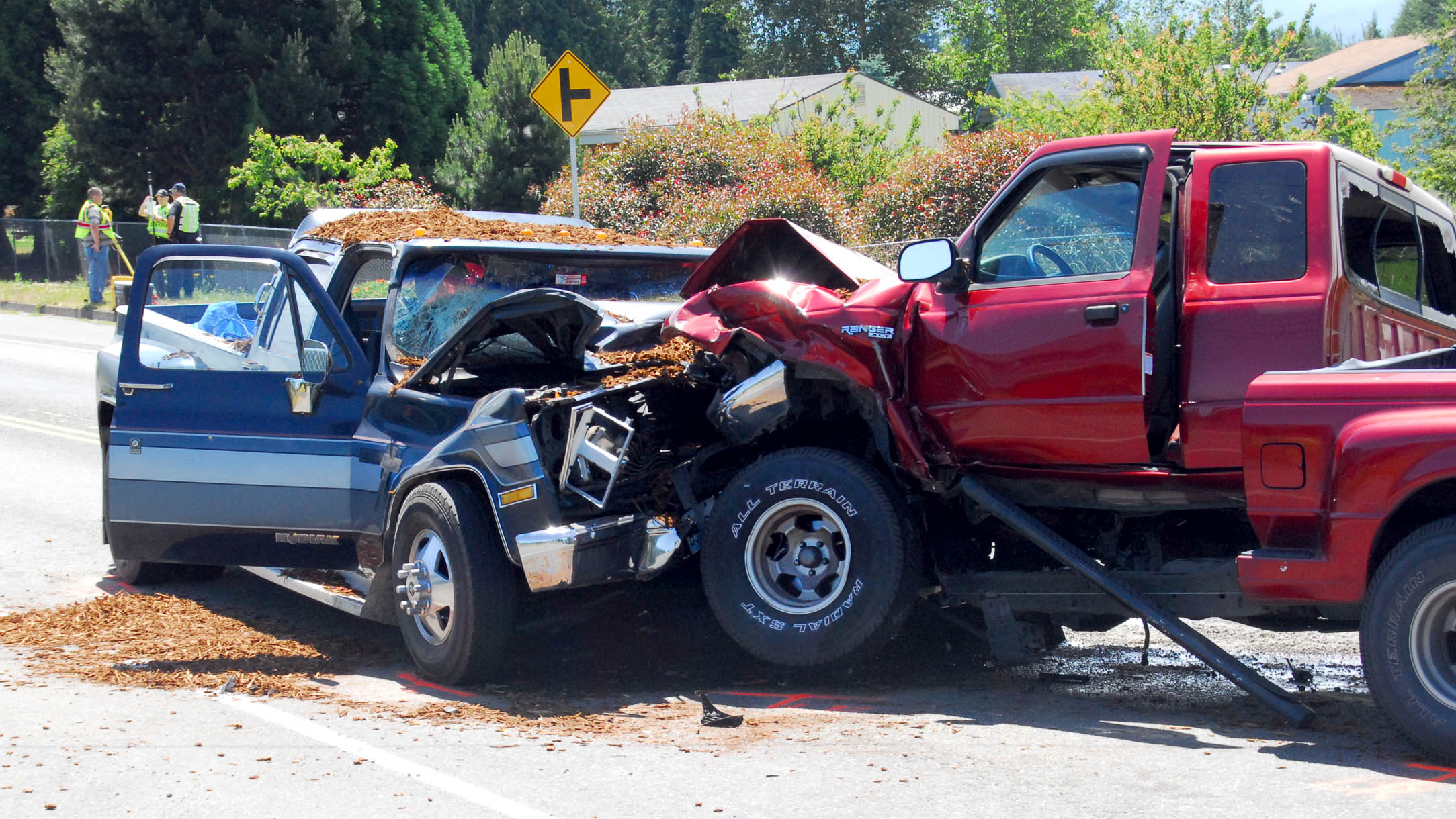 Accident investigators from the Clallam County Sheriff's Office and Sequim Police Department take mesurements at the scene of a collision between two pickup trucks on Old Olympic Highway near Mantle Road northwest of Sequim today. Keith Thorpe/Peninsula Daily News