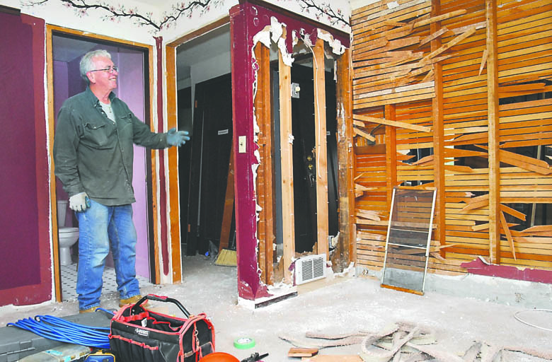 Jerry Hendricks points to a section of wall being demolished on the second floor of the Captain Joseph House in Port Angeles on Wednesday. Keith Thorpe/Peninsula Daily News