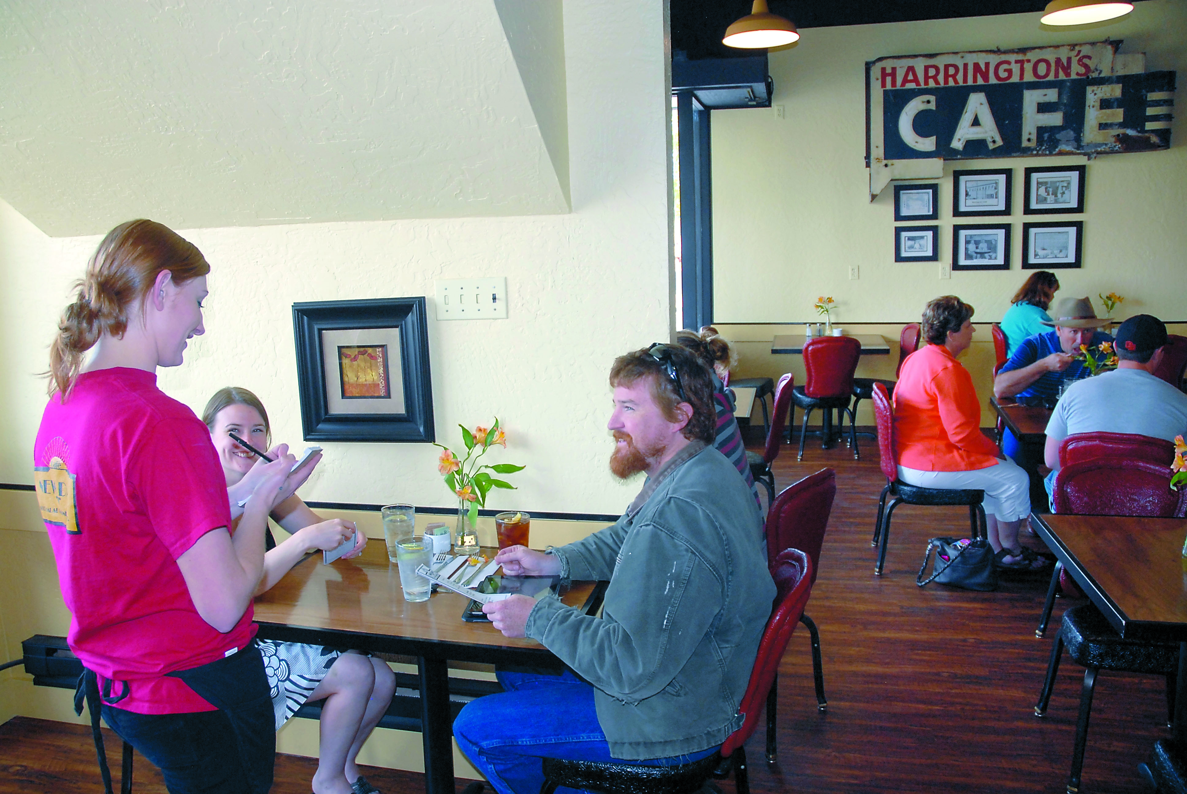 New Day Cafe employee Reagan Lausche takes the order of Toni Jensen