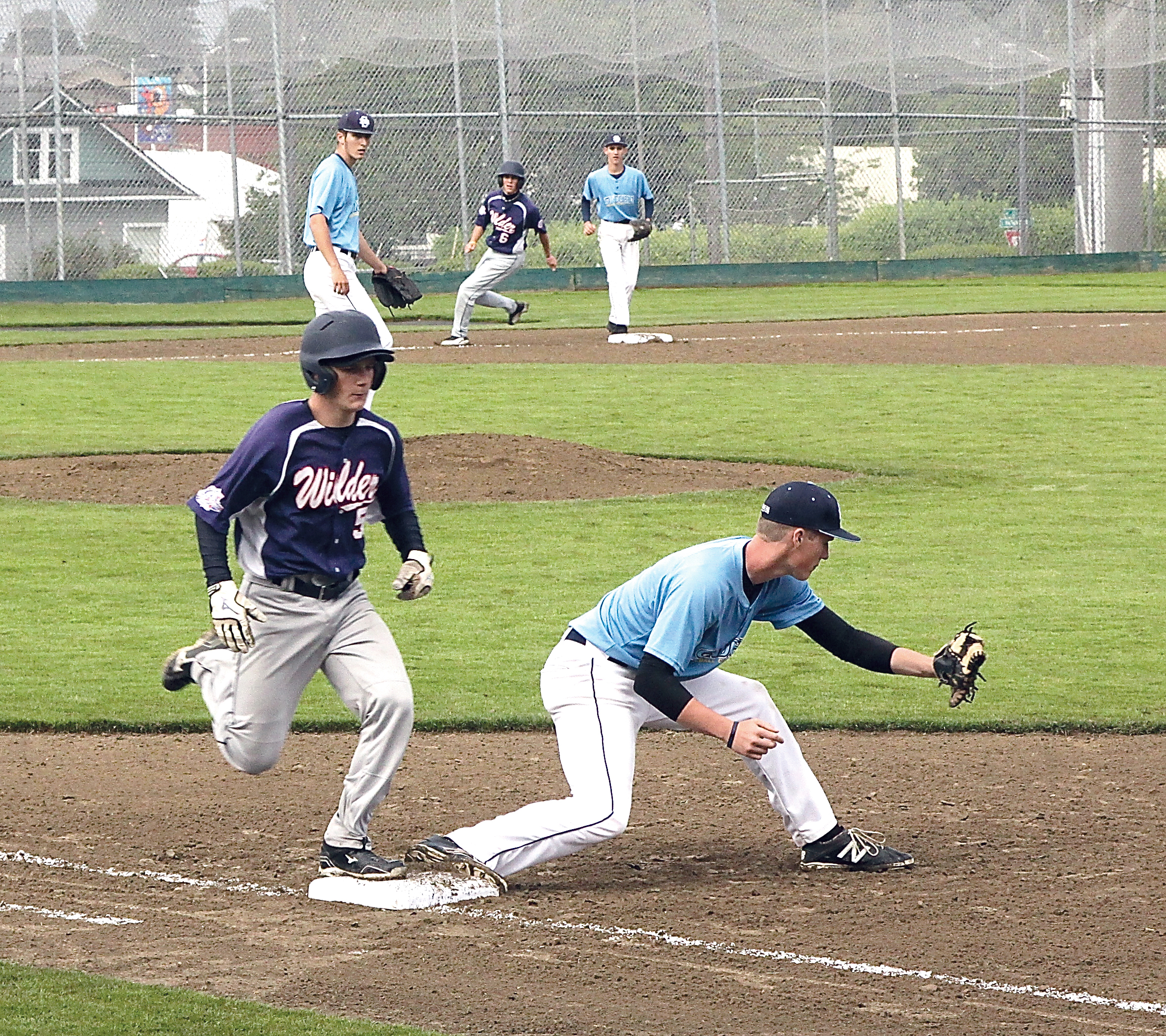 Wilder's Brett Wright is put out at first base by Sandberg's Bailey Powers as Wilder's Brady Konopaski