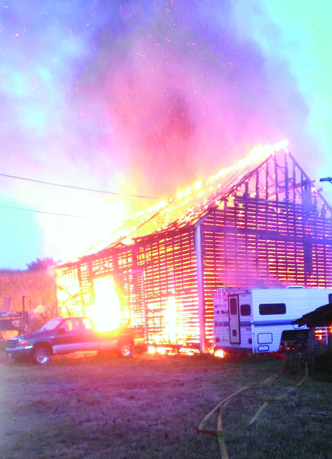An 1892 dairy barn in the Dungeness Valley goes up in flames Sunday at 121 Clary Lane. The cause is still unknown. Carla Morton