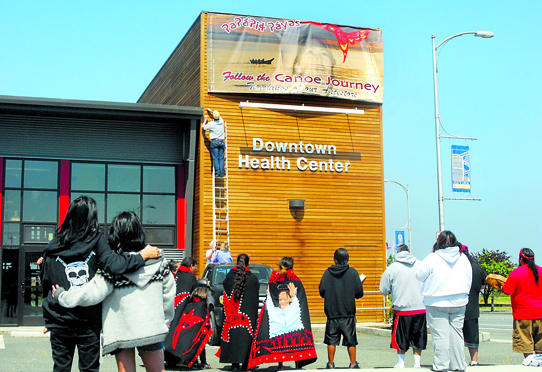 Members of the Lower Elwha Klallam tribe hold a ceremony as a banner is unfurled in downtown Port Angeles to pay tribute not only to the 2012 Canoe Journey but also to Vanna Francis