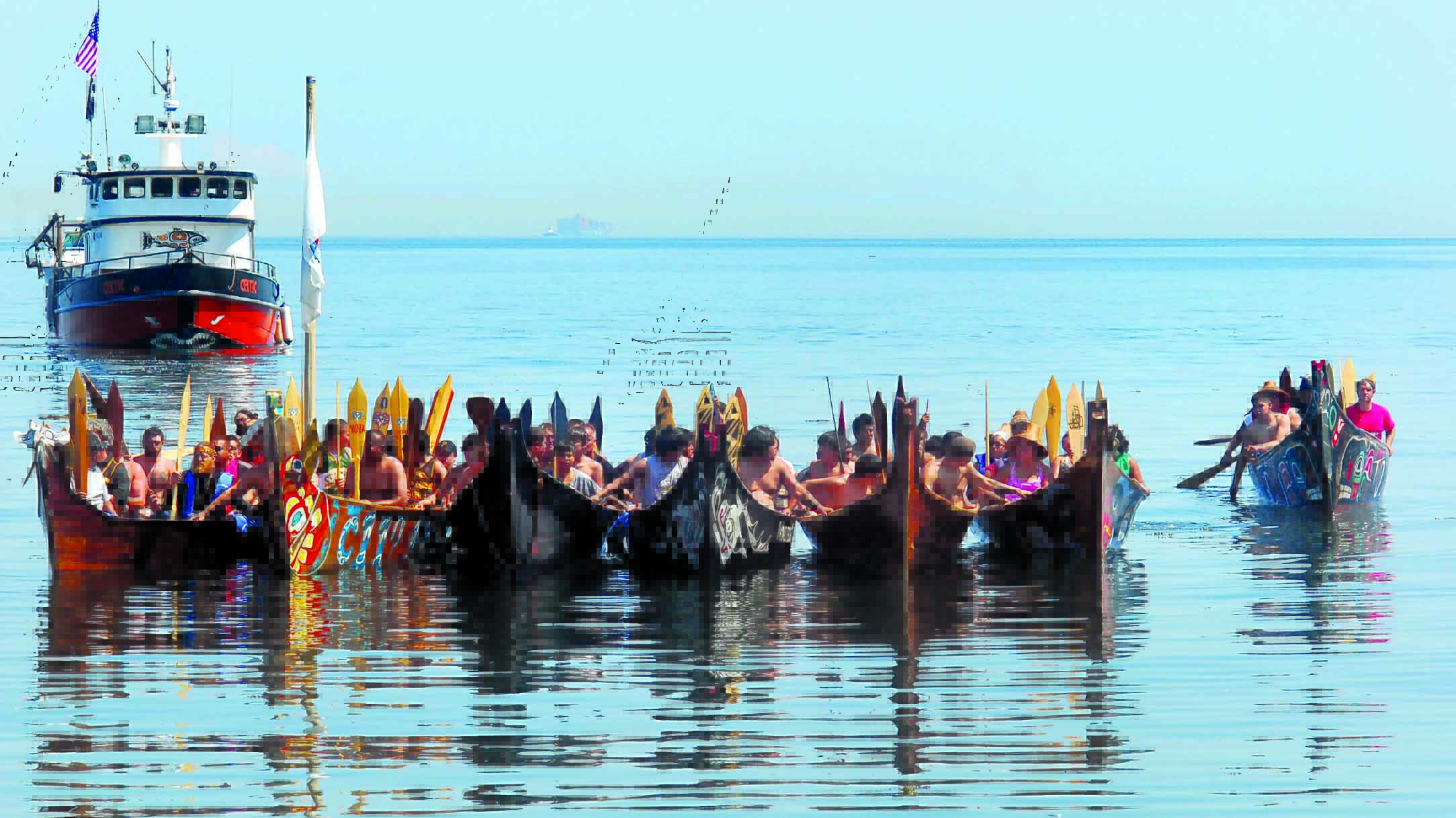 A flotilla of canoes representing the Quinault and Quileute tribes of the Pacific Coast