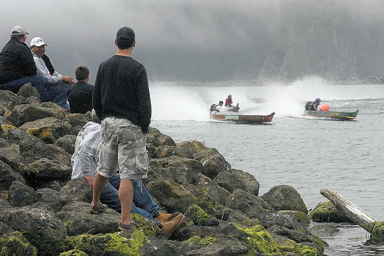 Cedar dugout canoes with 30- horsepower Mercury motors round the south turn on the Quillayute River during 2013's Quileute Days Festival. Lonnie Archibald/for Peninsula Daily News