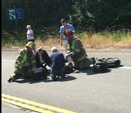 Sanders is attended at the accident scene in this photo by a passer-by Jennifer Deaton Jennifer Deaton (click on photo to enlarge)