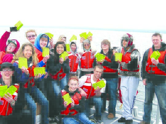 A group of students from Port Angeles' Lincoln High School get ready to release drift cards into the Strait of Juan de Fuca from a Coast Guard vessel earlier this year. Deb Volturno