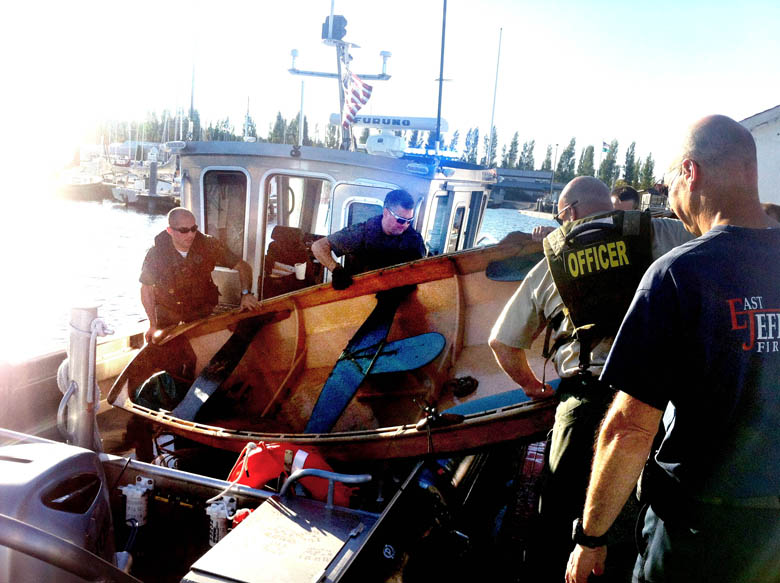 East Jefferson Fire-Rescue firefighters assist with a water rescue at about 6 p.m. Monday offshore from the Bayview Restaurant in Port Townsend.