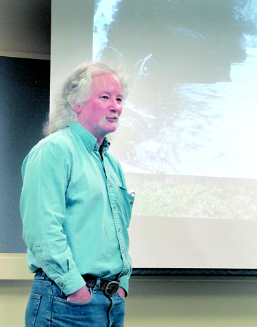 John Gussman presents a clip from his film "Return of the River" on Monday. Arwyn Rice/Peninsula Daily News