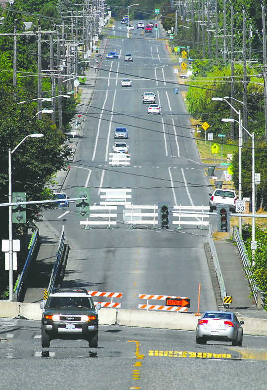 Traffic makes its way along Lauridsen Boulevard in Port Angeles on Tuesday as barricades mark a closed bridge over Peabody Creek. The crossing was barred Monday in preparation for replacement of the aging span. Keith Thorpe/Peninsula Daily News