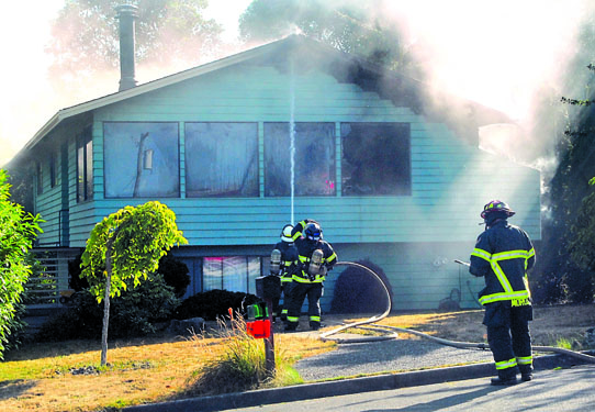 Port Angeles firefighters respond to a blaze at 1614 W. Eighth St. that reportedly began in a couch. Keith Thorpe/Peninsula Daily News