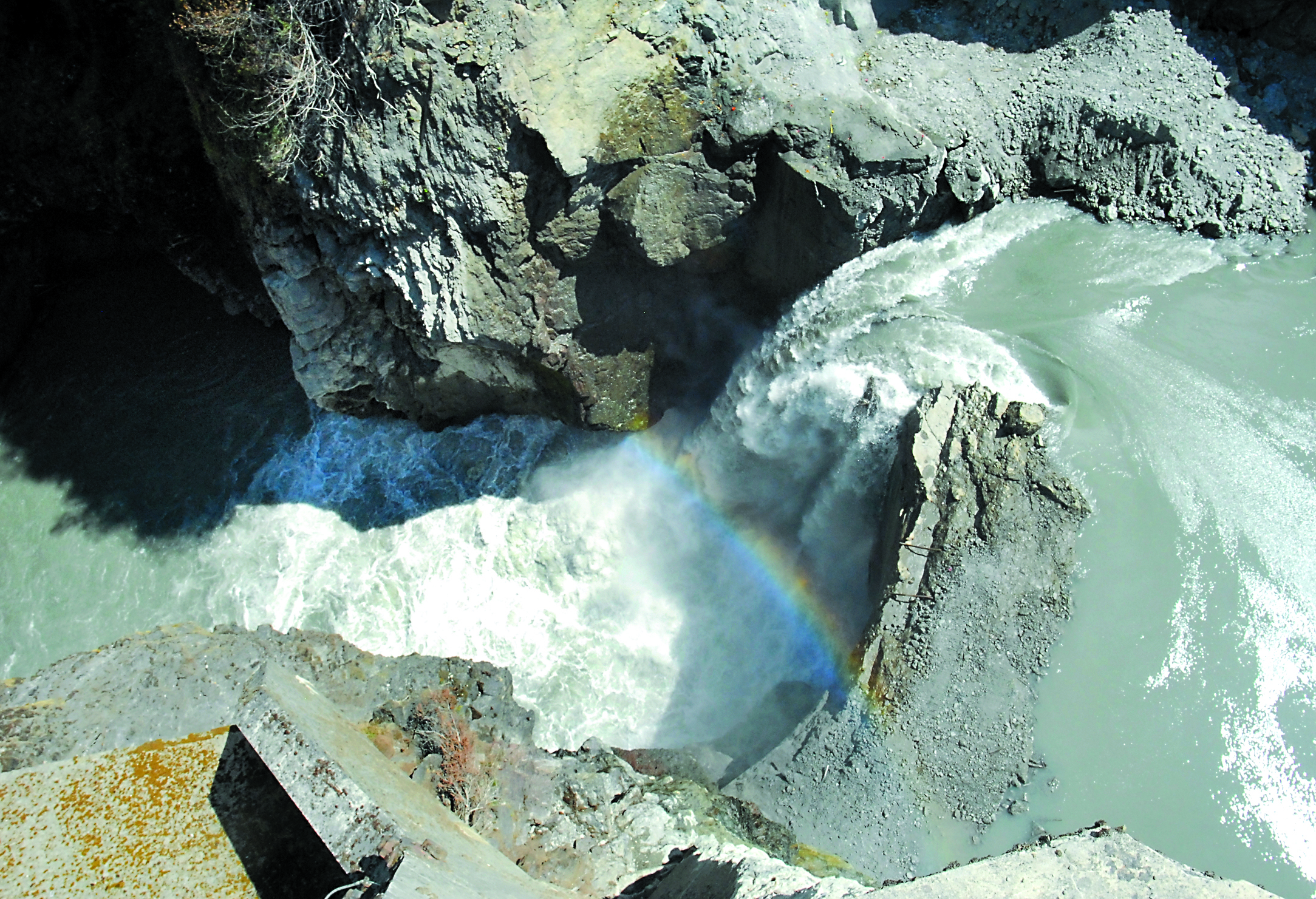 Water from the Elwha River flows over what remains of Glines Canyon Dam. The structure should be completely gone by early next summer. -- Photo by Keith Thorpe/Peninsula Daily News