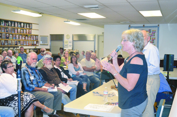 Val Phimister explains the charter process to a crowd of more than 100 people at the first home-rule charter forum. Charlie Bermant/Peninsula Daily News