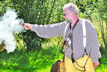 “Mountain man” Charlie Stowe of Black Diamond fires his Monarch 41-caliber black powder derringer at a target during the annual Green River Mountain Men Rendezvous in 2011. Peninsula Daily News