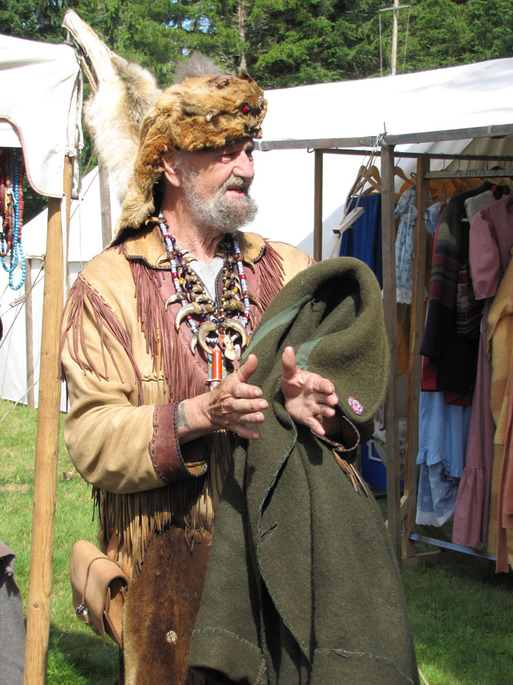 A mountain man called "Ram" regales "flat-landers" with tales of his backwoods adventures at the annual Mountain Man rendezvous near Sequim. Arwyn Rice/Peninsula Daily News