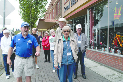 Passengers from the American Cruise Lines vessel American Spirit walk along East Front Street in downtown Port Angeles on one of Don Perry's underground heritage tours Wednesday morning. Jeremy Schwartz/Peninsula Daily News