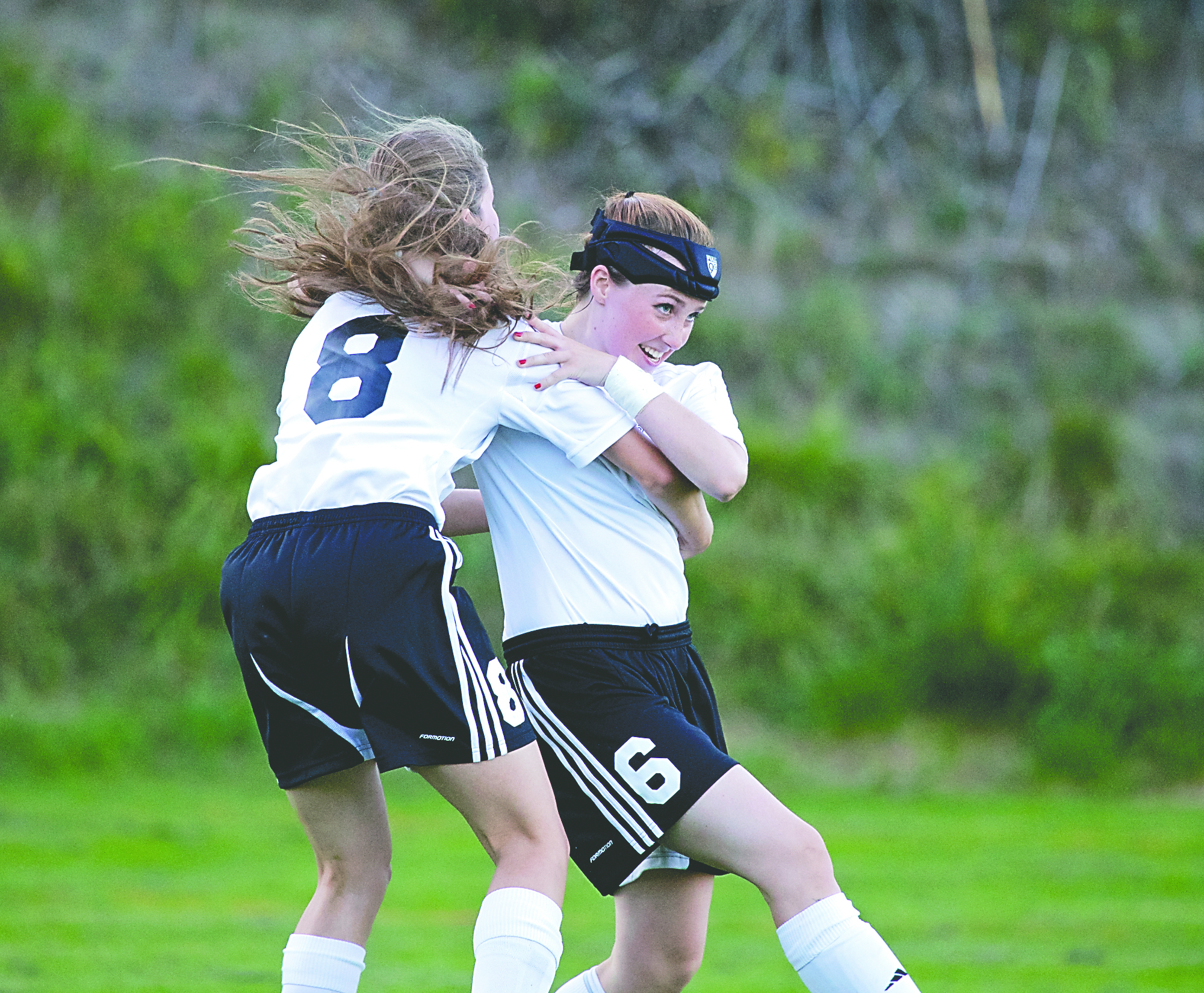 Port Townsend's Lily Murock (6) receives a congratulatory hug from teammate Jewel Johnson after Murock scored the Redskins' first goal of the season. Steve Mullensky/for Peninsula Daily News