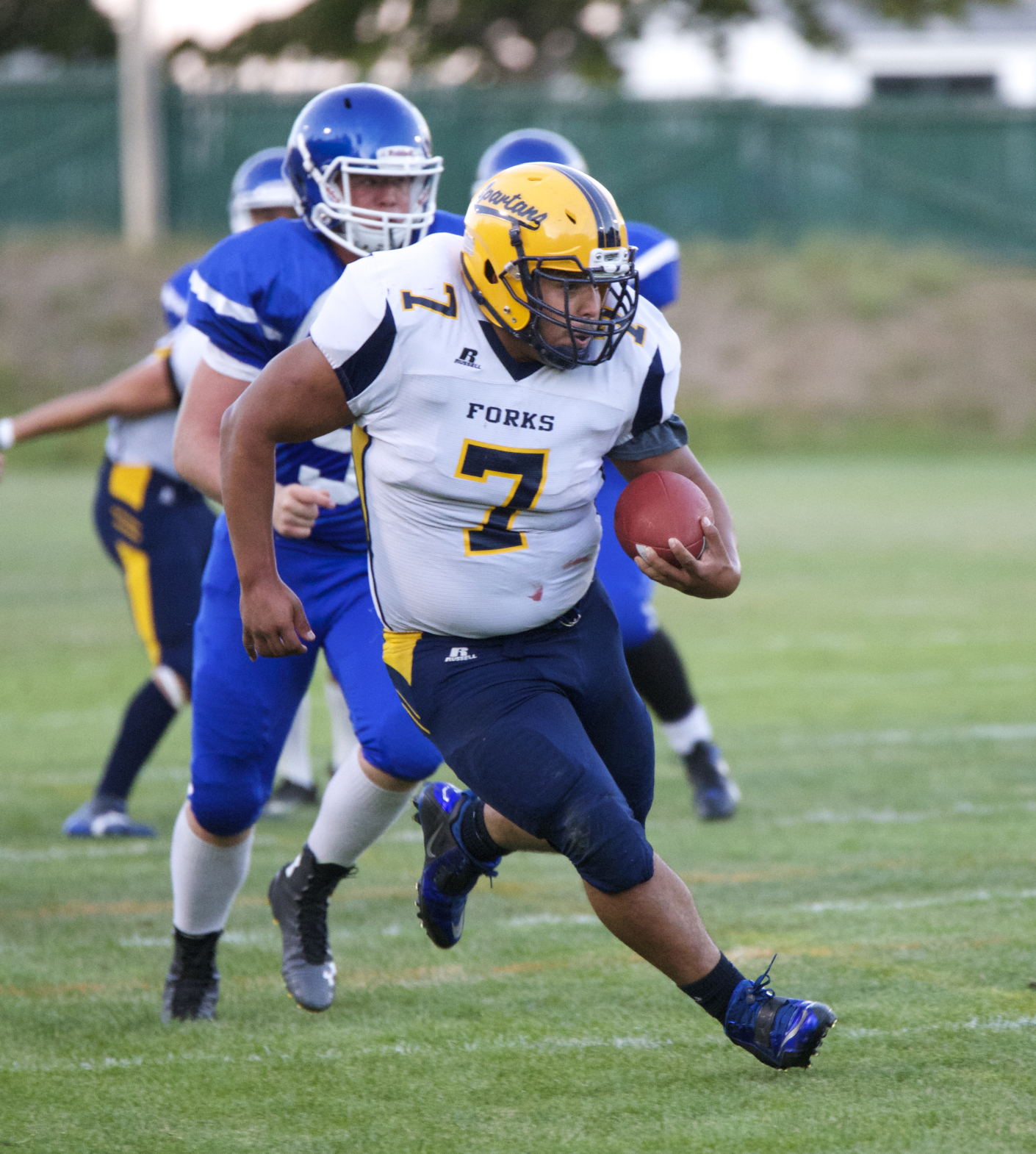 Forks fullback Miguel Morales (7) rumbles for one of his three first-half touchdowns against Chimacum. Steve Mullensky/for Peninsula Daily News
