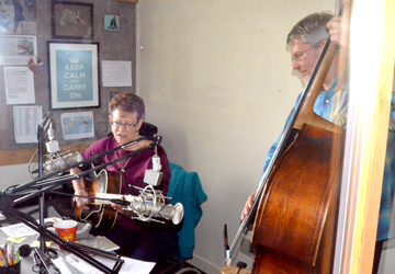 Sylvia Heroldand Chuck Ervin perform on the air at KPTZ-FM. The nonprofit radio station is one of the tenants of Mountain View Commons that will meet with the city of Port Townsend today.  -- Photo by Charlie Bermant/Peninsula Daily News
