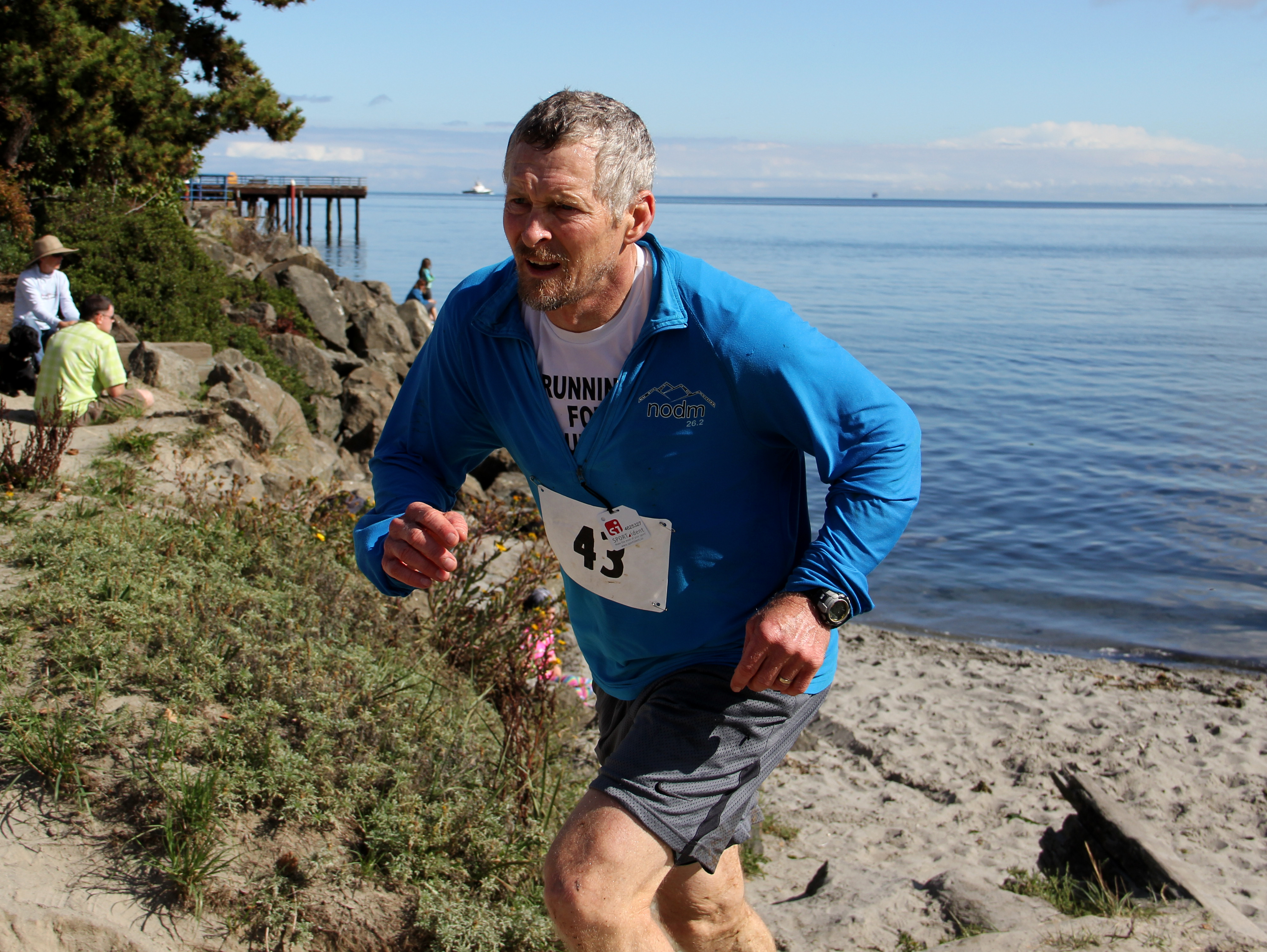 Tom Wahl runs on Hollywood Beach as he switches from the kayak portion of The Big Hurt to the road bike stage last week. Wahl participated in the event less than four months after surgery for prostate cancer. Anita Martin