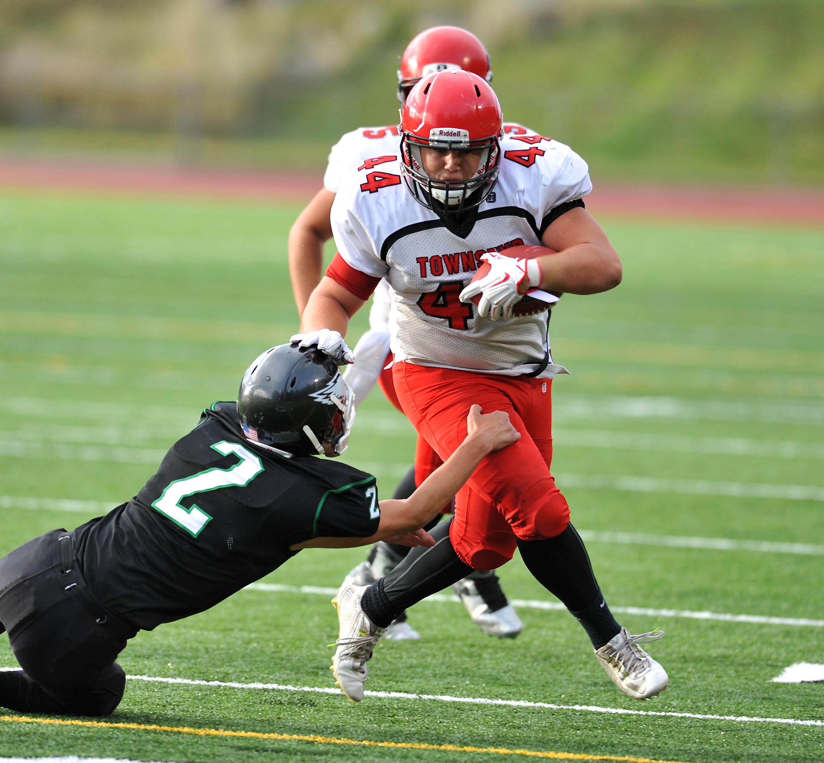 Port Townsend's Wesley Wheeler runs through a tackle by Klahowya's Payton Ryen last month. The eighth-ranked Redhawks face rival Chimacum tonight. Jeff Halstead/for Peninsula Daily News