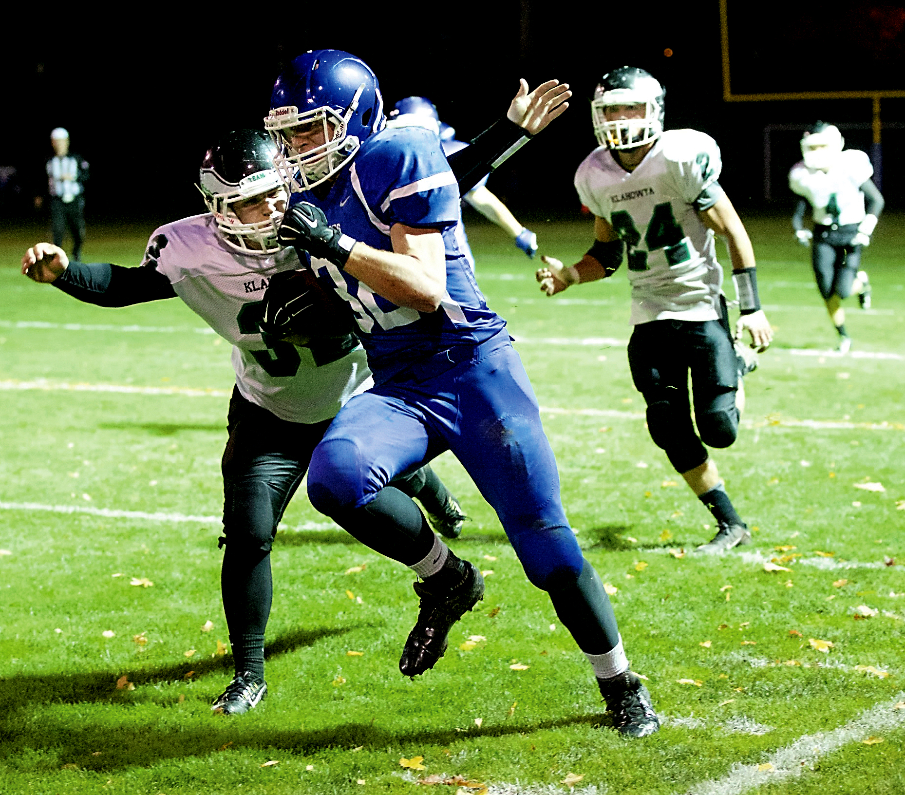 Klahowya linebacker Austin Keller tackles Chimacum's Sam Golden  at the end of a big gain by Golden at Memorial Field. Steve Mullensky/for Peninsula Daily News