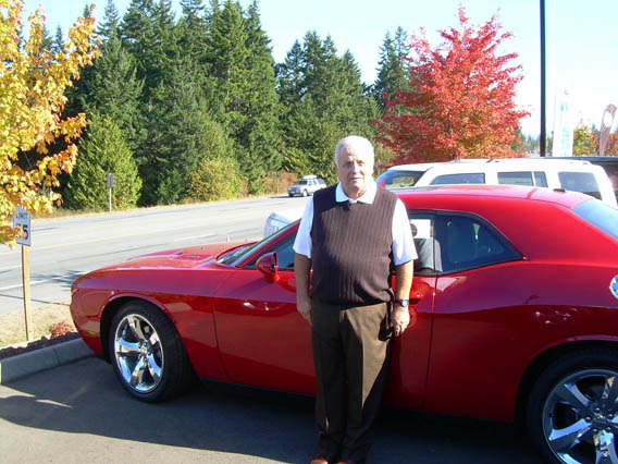 Dan Wilder stands with a Dodge Challenger R/T at his dealership