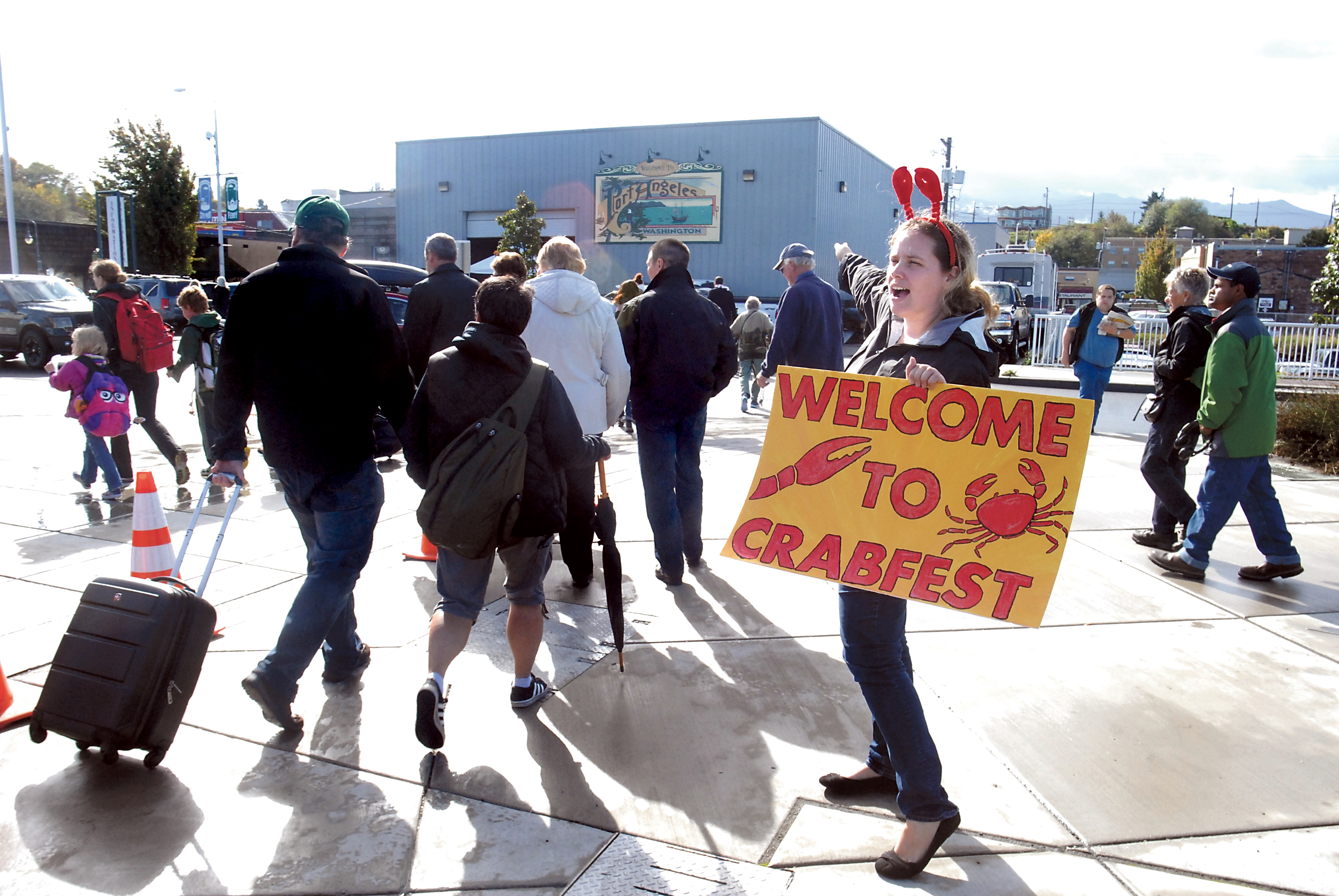 Black Ball Ferry Line employee Rochelle Roberts of Victoria directs offloading MV Coho ferry passengers to the Dungeness Crab & Seafood Festival tent on Saturday. Keith Thorpe/Peninsula Daily News