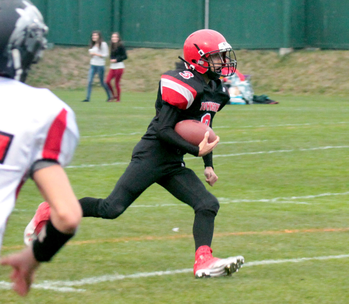Port Townsend's Jacob Ralls (3) looks for space to run in the Redhawks' 56-20 win over Coupeville. Shawn King/for Peninsula Daily News