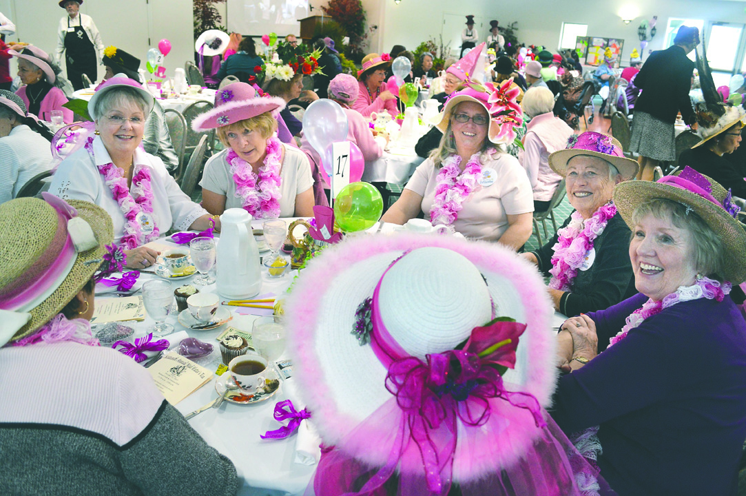 All pinked out in their hats and leis are