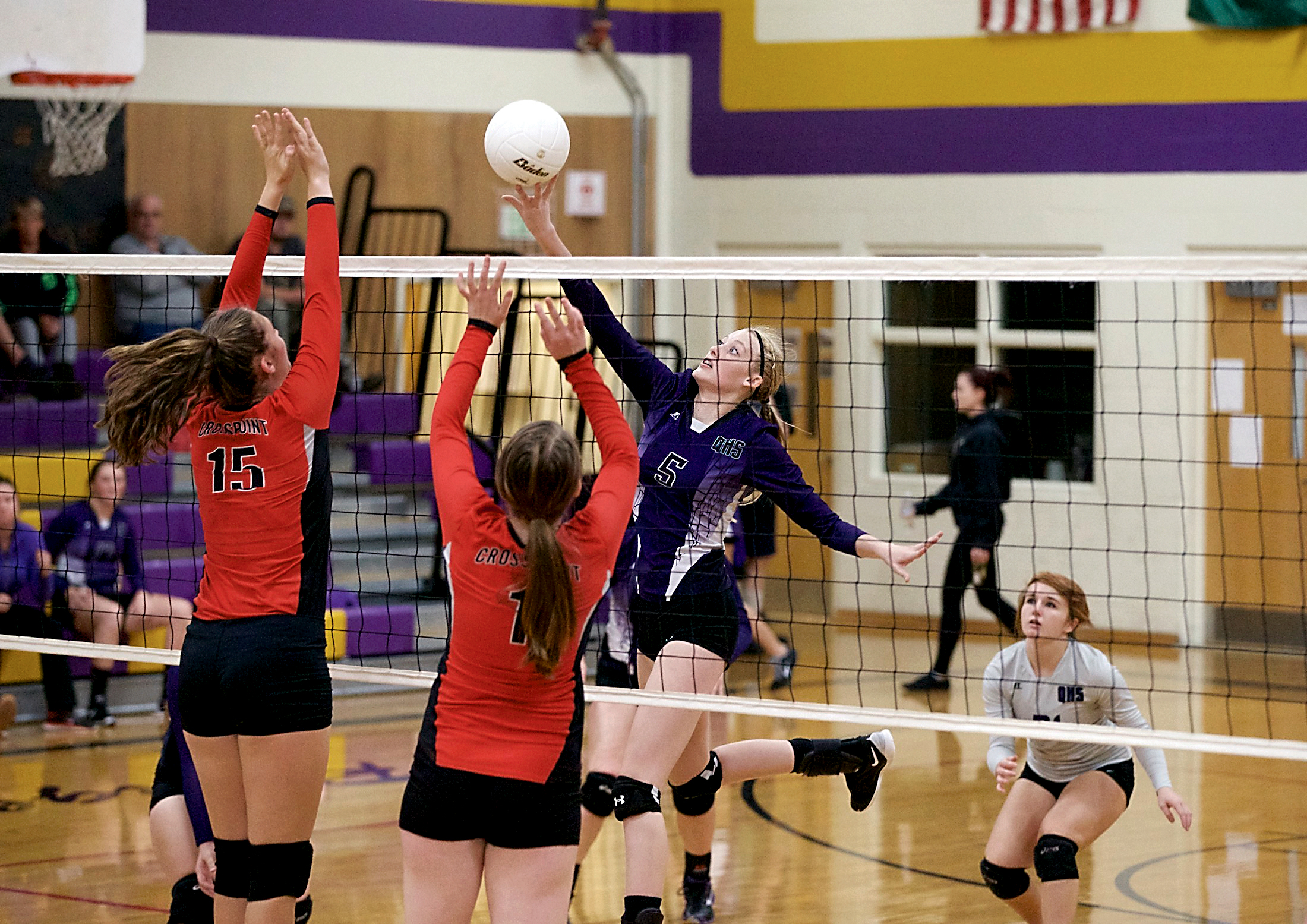 Quilcene's Elysah Schryver (5) tips the ball over the fingers of Cr