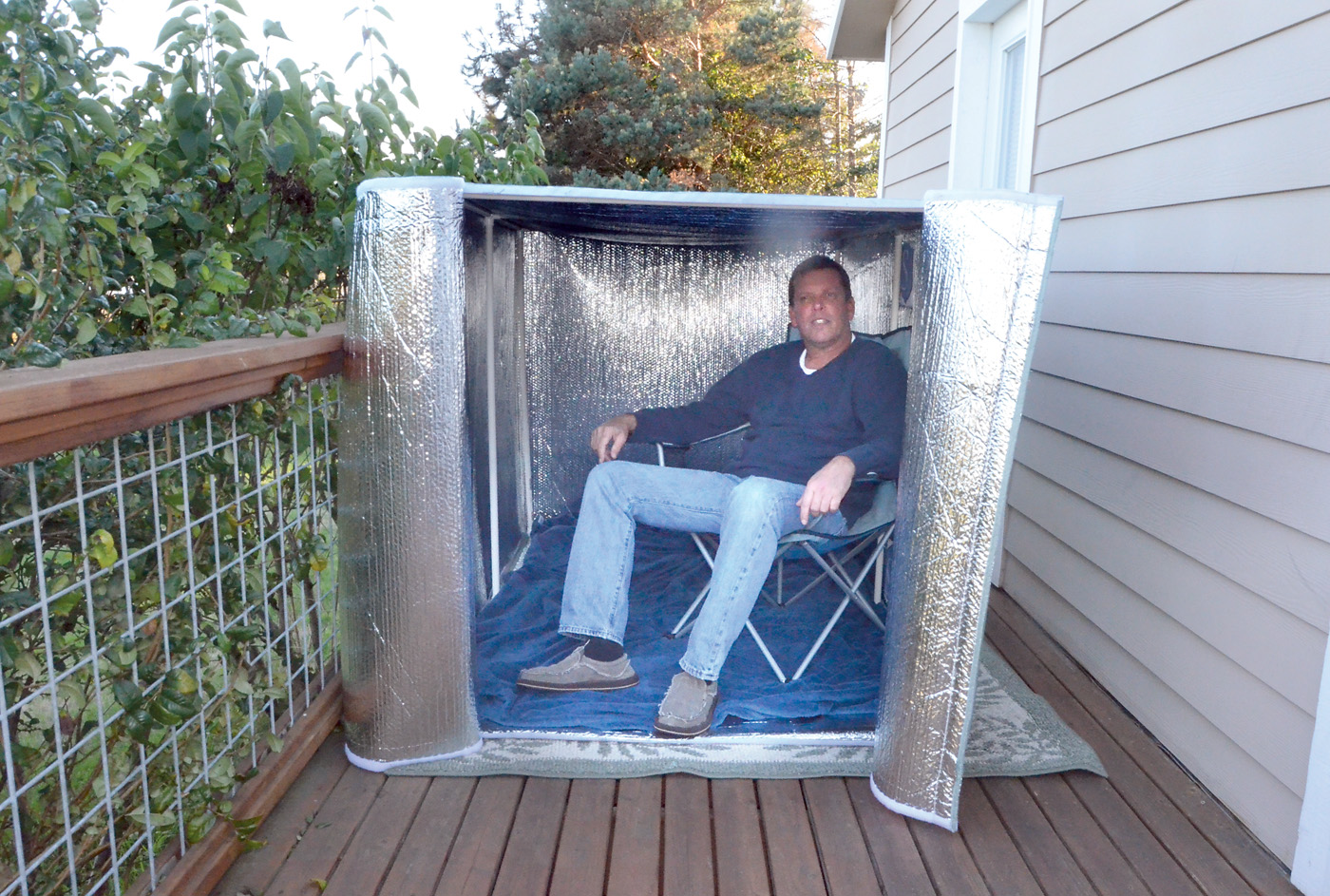 Inventor Rick Thompson sits inside a portable shelter