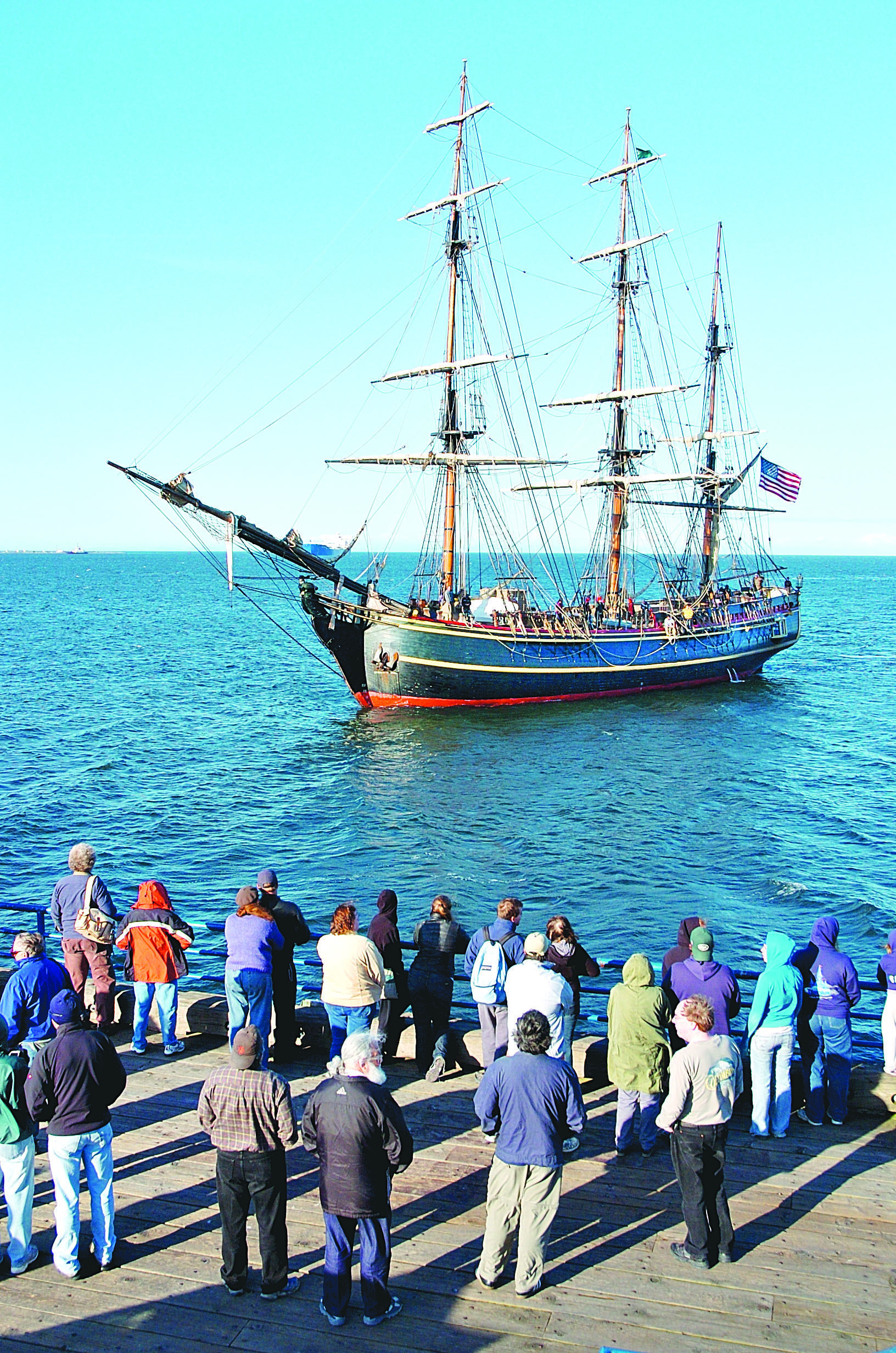 Spectators watch as the HMS Bounty arrives at Port Angeles City Pier in June 2008. Peninsula Daily News