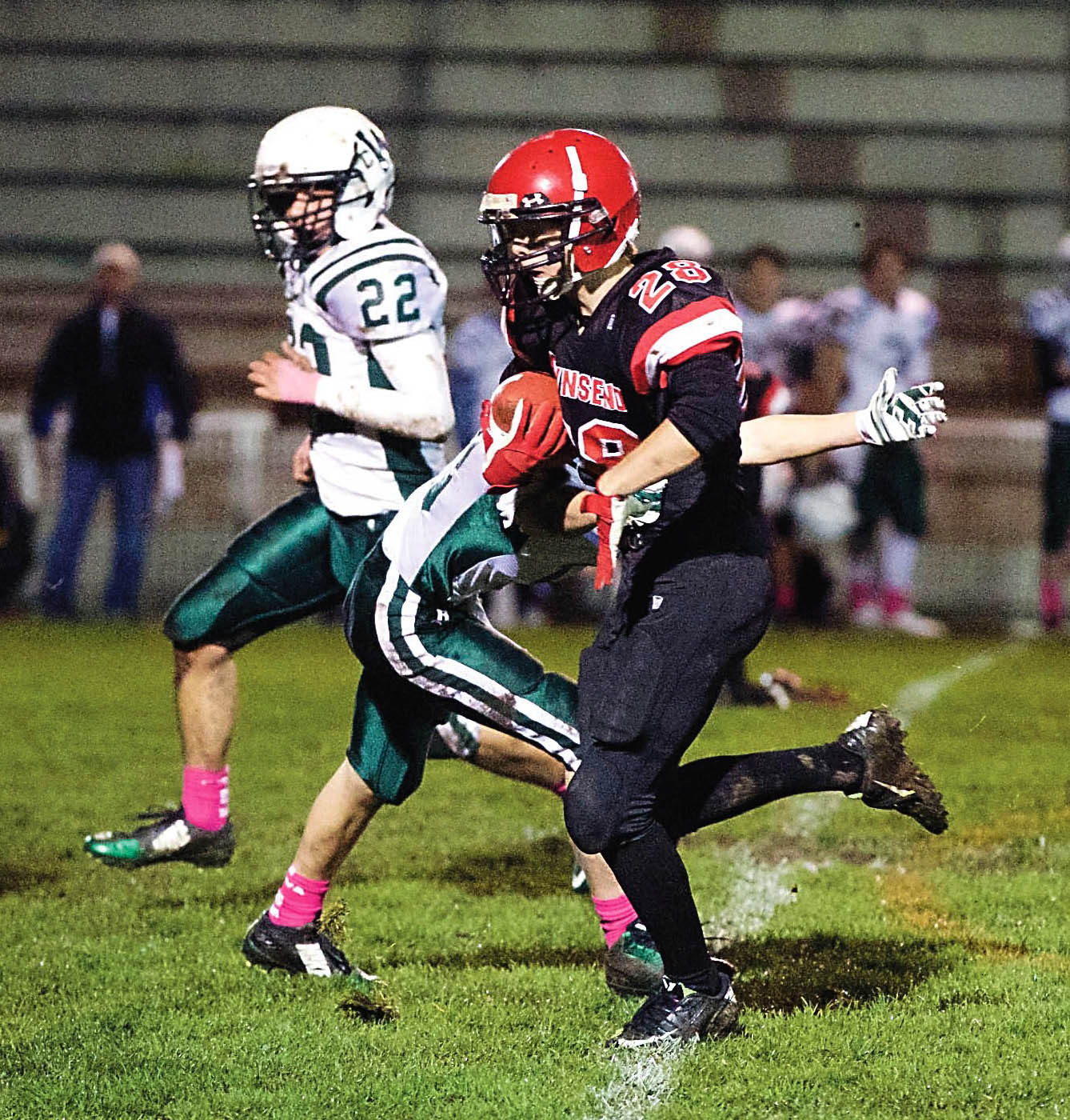 Port Townsend's Isaiah Mason (28) evades a tackle and rushes for a first down against Charles Wright. Steve Mullensky/for Peninsula Daily News