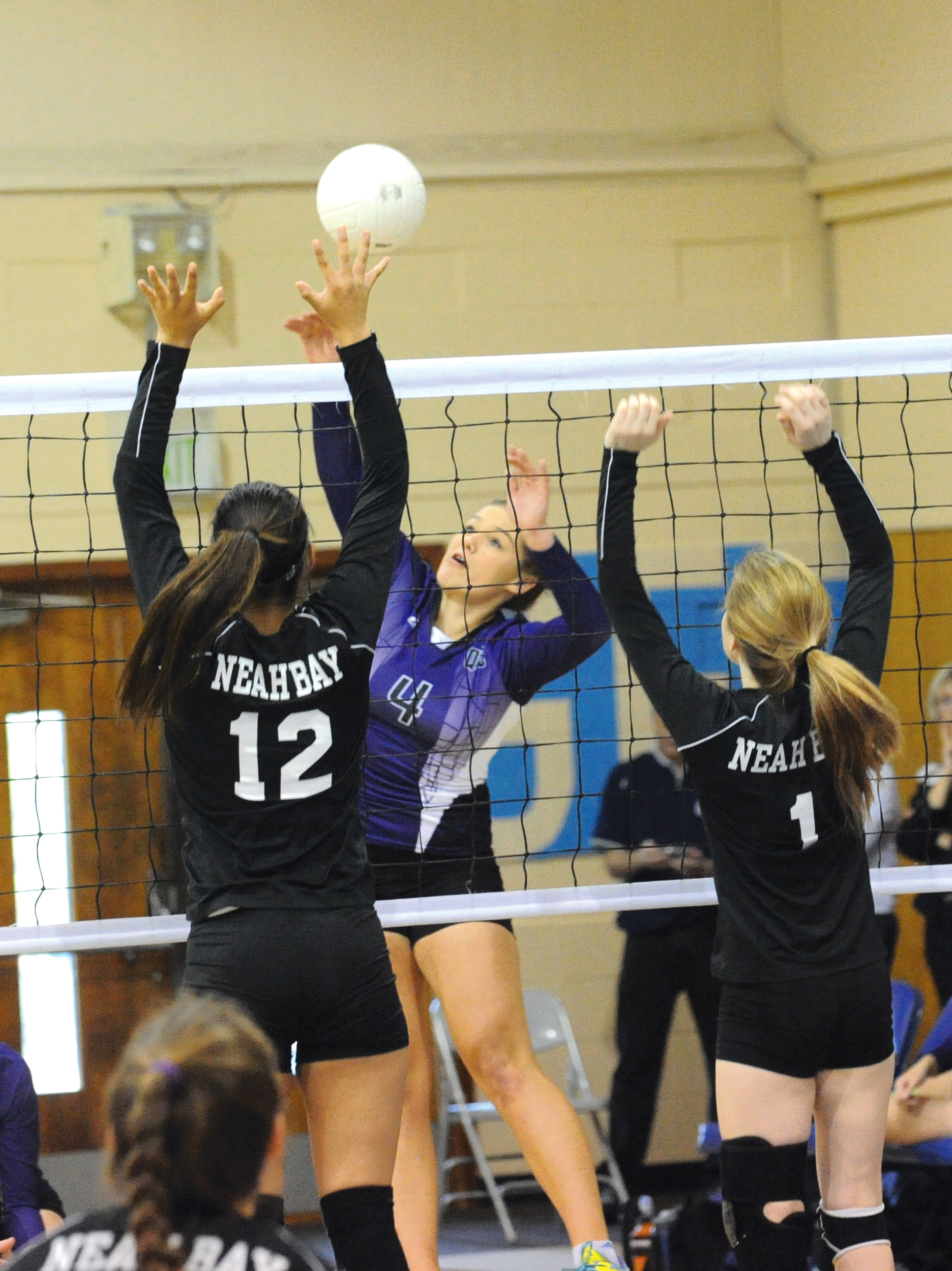 Quilcene's Sammy Rae (4) battles at the net with Neah Bay's Vonte Aguirre (12) and Morgan Buzzell (1) at Crescent High School. The Rangers won in three sets. Lonnie Archibald/for Peninsula Daily News