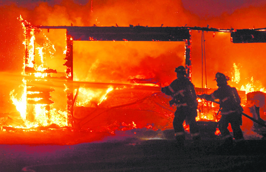 Firefighters battle a blaze that broke out in a garage on South Tiller Road in Port Angeles. Keith Thorpe/Peninsula Daily News