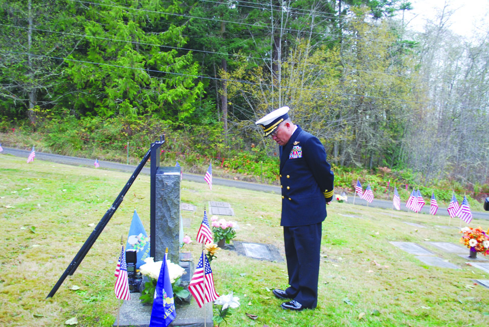 Navy Command Chaplain Don Biadog reflects in front of Marvin G. Shields grave at Gardiner Community Cemetery on Monday. Charlie Bermant/Peninsula Daily News