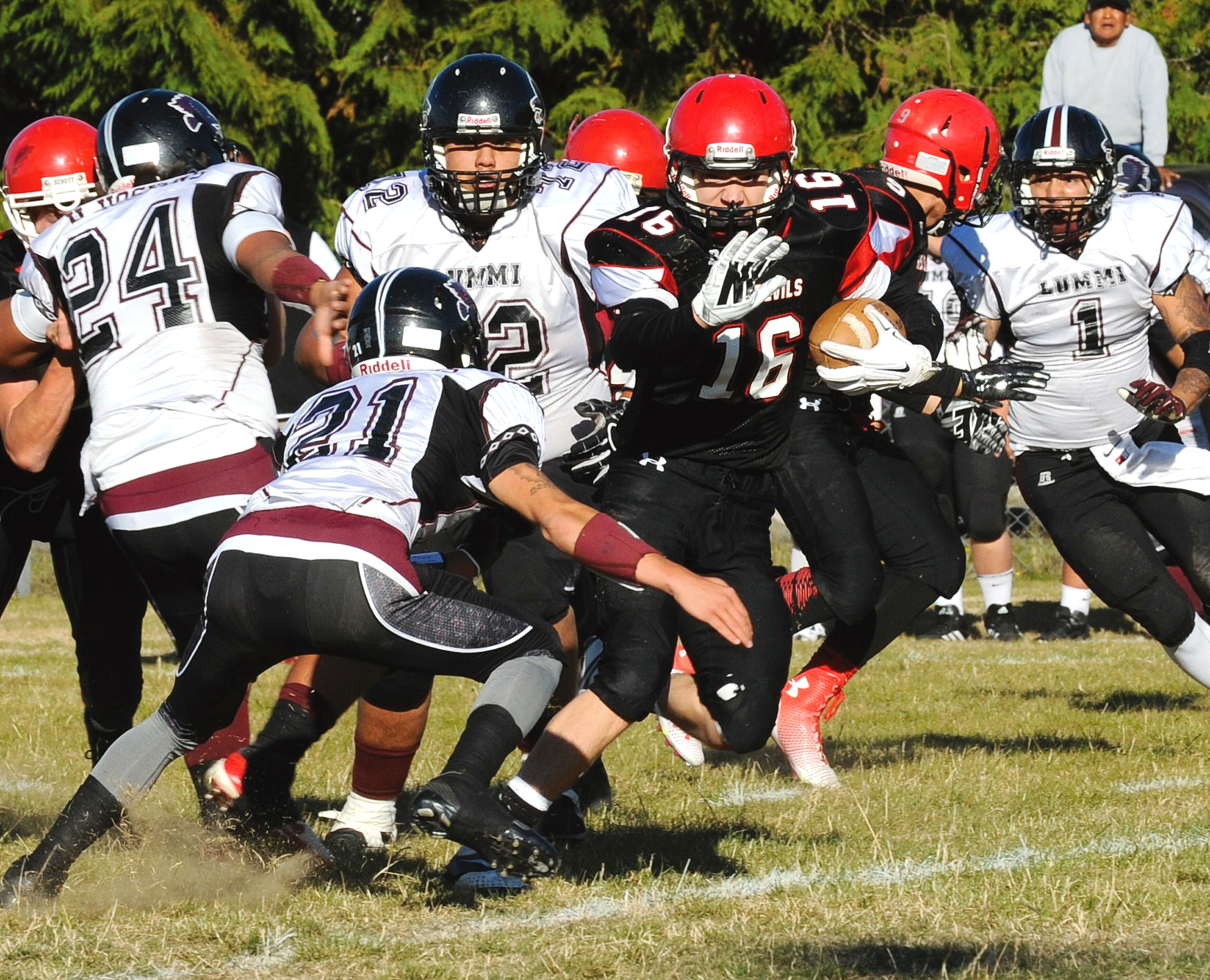 Neah Bay running back Cole Svec (16) runs away from Lummi's Dino Williams (21) during the teams' meeting in Neah Bay earlier this season. Lonnie Archibald/for Peninsula Daily News
