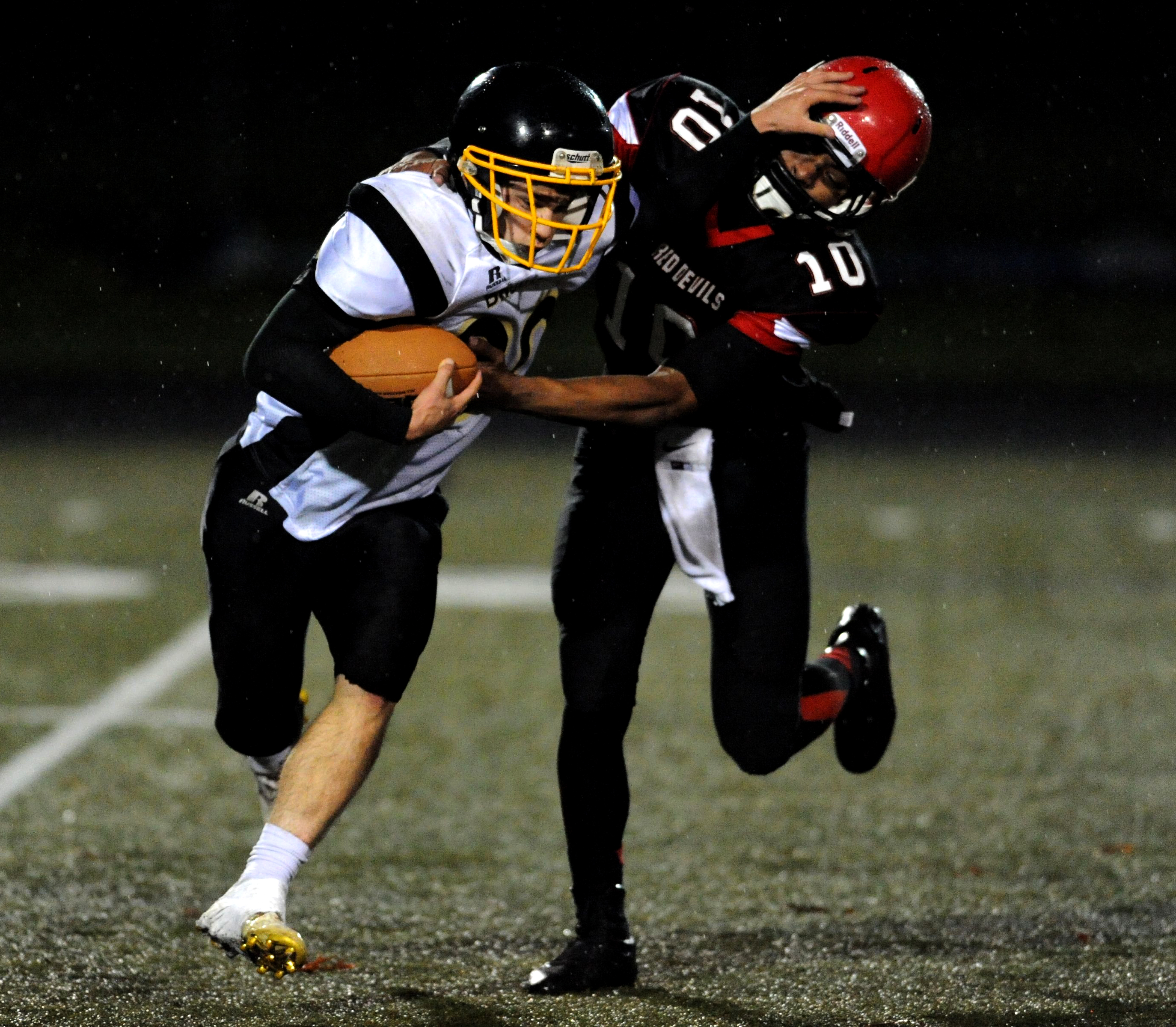 Clallam Bay's Clayton Willis stiff-arms Neah Bay's Rwehabura Munyagi Jr. Jeff Halstead/for Peninsula Daily News