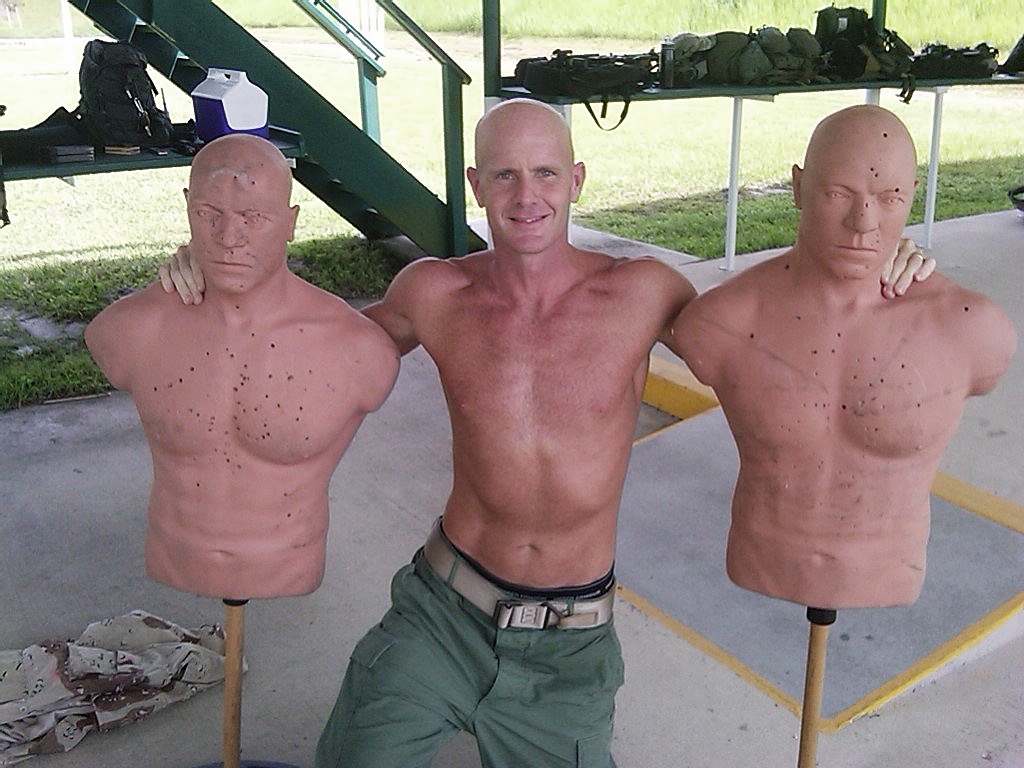 This undated photograph obtained by The Seattle Times shows FBI Special Agent Frederick W. Humphries posing with target dummies following a SWAT practice in an unknown location. The Times says Humphries sent the photograph to friend and Florida socialite Jill Kelley and others