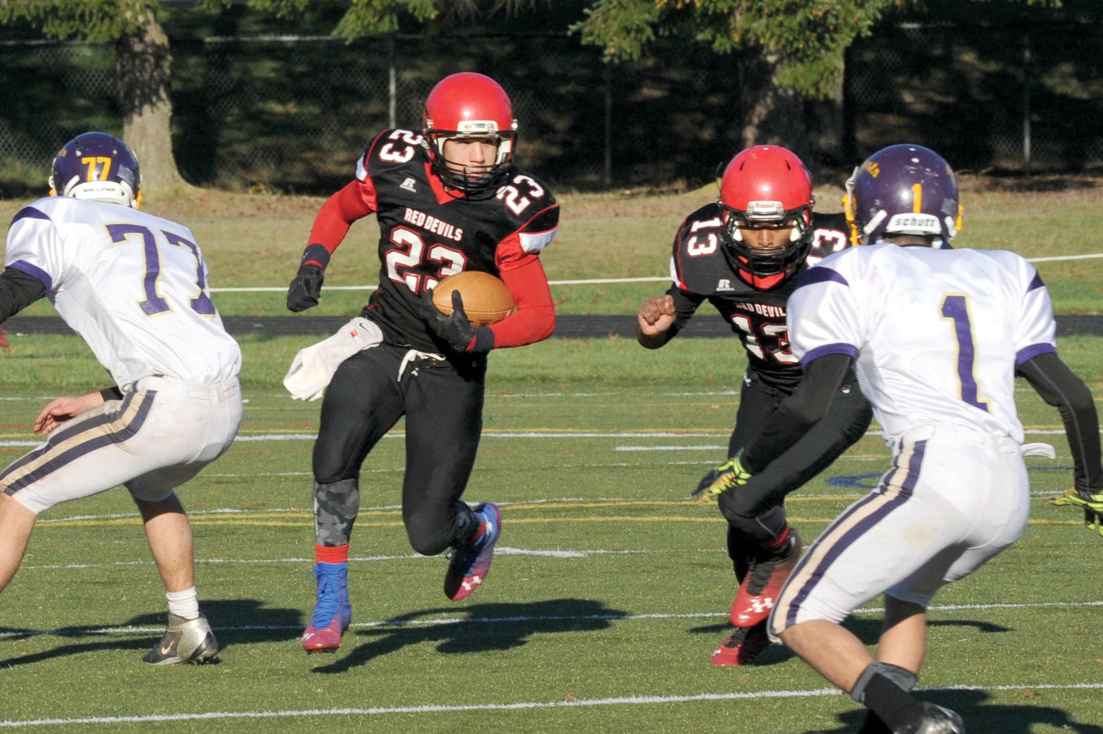 Neah Bay's Chris Martinez (23) looks for running room behind the blocking of quarterback Rwehabura Munyagi (13). Lonnie Archibald/for Peninsula Daily News