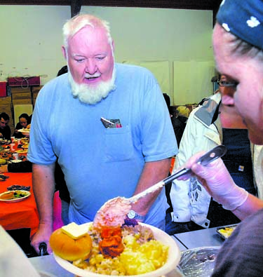 Harry Henningsen of Port Angeles watches as volunteer Christa Scott