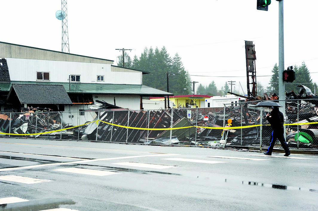 The charred remains of the International Order of Odd Fellows hall are seen Sunday in Forks. Lonnie Archibald/for Peninsula Daily News