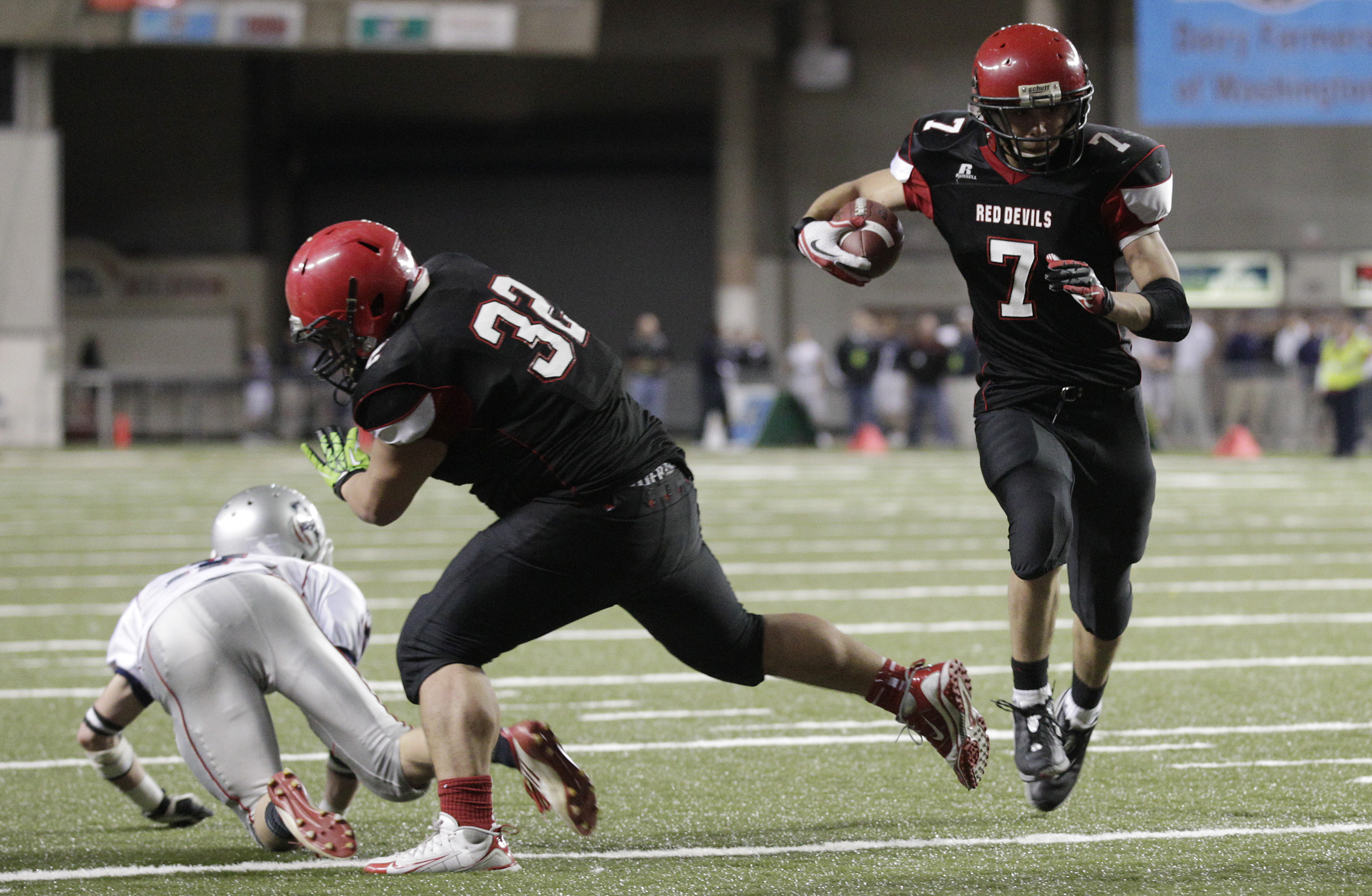 (*Click on gallery below for more photos*) Neah Bay's Cody Cummins (7) runs the ball as Tyler McCaulley (32) blocks against Liberty Christian in the second half of the 1B division high school state championship football game on Saturday. The Associated Press (click on photo to enlarge)