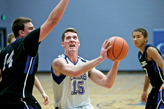 Chimacum's Sam Golden eyes the basket while defended by North Mason's Zac Marks as the Bulldogs' Trey Fisher looks on. Steve Mullensky/for Peninsula Daily News